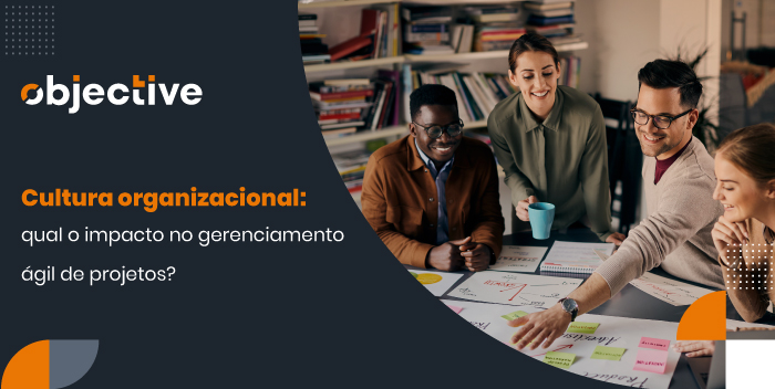 quatro pessoas trabalahdno em uma mesa com post its e cartolinas. Ao lado o título do artigo: "Cultura organizacional: qual o impacto no gerenciamento ágil de projetos?"